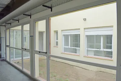 Corredor de la UTI pediátrica con paños fijos de aluminio modena blanco al patio interno