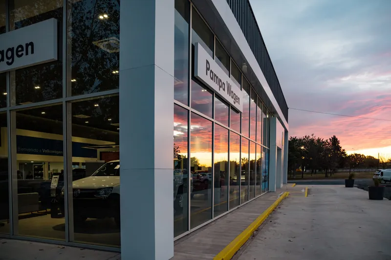 Lateral del concesionario y perfilería de aluminio al atardecer